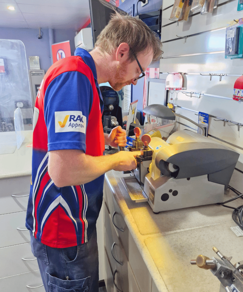Morayfield Locksmiths technician cutting a key in Caboolture workshop providing key duplication and locksmith services in Moreton Bay