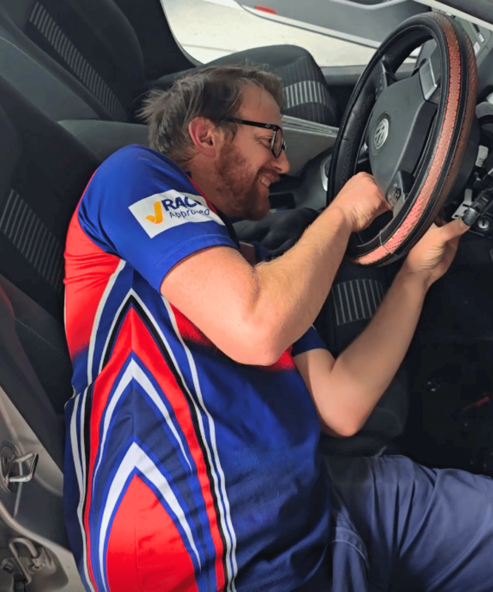 Morayfield Locksmiths technician seated in a vehicle repairing and reprogramming a faulty ignition key for a customer in the Moreton Bay region