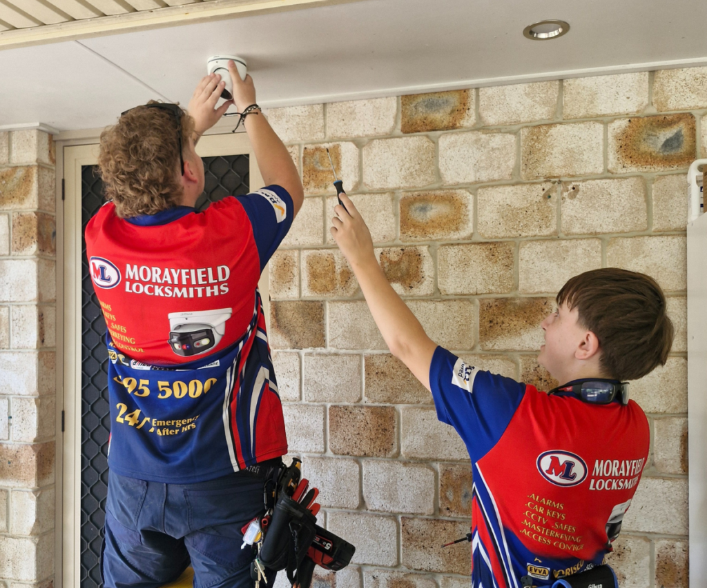 Outdoor CCTV security camera installation on warehouse wall in Moreton Bay.