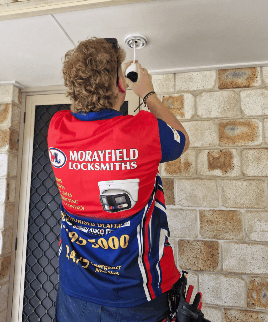 Morayfield Locksmiths technician installing CCTV security camera at a commercial property in Moreton Bay.